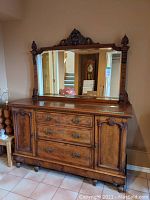 Full view of solid wood dresser with mirror showing carved details, drawers, cabinets, and crack on top