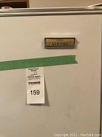 Close-up photo of the Eaton Viking badge on the freezer door, showing brand details.