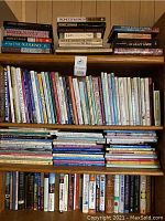 Full bookshelf showing a wide variety of books including crafting, gardening, decorating and general topics.