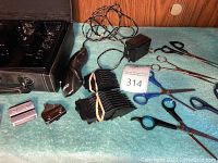 Overview of Conair clipper, power cord, two clipper heads, multiple clipper guards, and several cutting shears