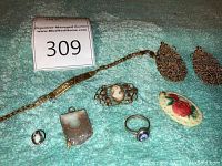 Group shot of eight jewelry pieces on blue towel