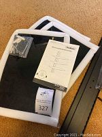Photo of DVD wall mount packaging, instructions and screws