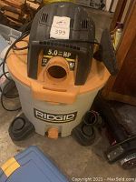 Photo of Ridgid shop vacuum showing the motor and 12 gallon container, marked with horsepower and capacity labels.