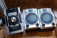 Sony MHC-EC55 CD player with two large speakers showing front and side view of speaker details
