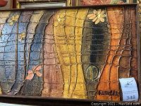 Full view of textured vintage art palette with earth tone colors and floral patterns