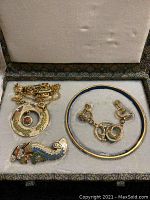 Jewelry set in box including necklace, earrings, bangle, and brooch