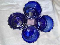 Top view of four cobalt blue hand blown glasses showing color and interior detail