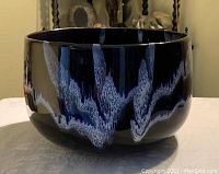 Side view of the Blue Mountain Pottery bowl showing the textured glaze with blue, black, and white colors.