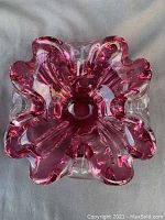 Top view of the signed pink Chalet art glass bowl showing its ruffled edges and flower-like shape.