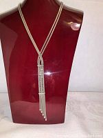 Front view of sterling silver Dyadema necklace on display stand showing overall design and length.