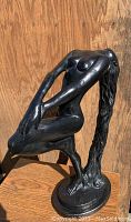 Front view of the black female nude sculpture showing the bent-backwards pose and flowing hair.