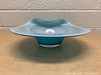 Side view of the bowl emphasizing the height and wavy rim design.