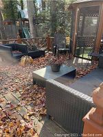 Deck scene showing sofa, side chair and matching low table with leaves.