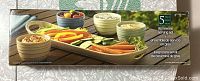 Photo of the boxed 5-piece stoneware serving set showing platter and bowls with fresh vegetable snacks for illustrative purposes.