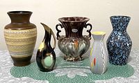 Front view of all five ceramic vases showing various shapes and colors