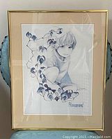 Framed lithograph showing the full artwork and frame, child figure with surrounding leaves.
