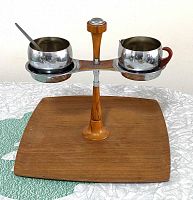Top view of the chrome and bakelite cream and sugar set mounted on the teak wood serving tray.