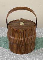 Front view of the vintage Kodiak ice bucket showing wood grain design, lid and handle.