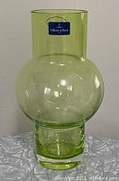 Front view of the green glass vase showing the Villeroy & Boch sticker on upper neck.