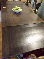 Top surface close-up showing wood grain, dark finish and center seam
