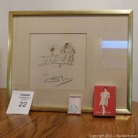 Framed nude girl drawing with flower, flip coin in pink box, and Nichigeki Music Hall matchbox