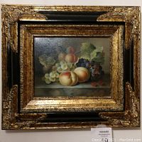 Frontal view of the first still-life painting showing fruit in an elaborate black and gold frame.