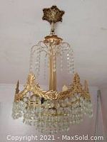 Full crystal chandelier with gold-tone metal frame, hanging crystal bead strands, and three bulb sockets.