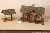 Side view showing station and separate platform with roof over yellow box