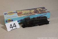 Photo showing the HO scale Pennsylvania engine locomotive next to its original Athearn box and lot number 44 sign.