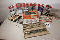 Full lot including scenery components, lampposts, string lights, metal trees, and Plasticville Freight Station building.