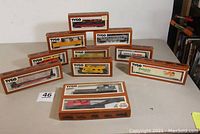 11 Tyco HO scale rolling stock items arranged on table, all boxed