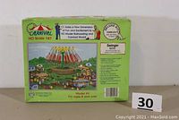 Photo of the front of the sealed box showing the brand Carnival, scale 1:87, and kit number 5213 with a colored image of the finished model including carnival figures and rides.