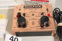 Close-up of top panel of Dual Pack 770 transformer showing two large black knobs for independent cab controls, master switch, and labels.