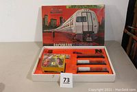 Top view of full set inside original box with orange insert and transformer included. Box shows Bachmann branding and N Scale logo.