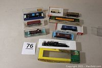 Overview of all eight train items including the locomotive, tender, and seven freight cars, all laid out on a surface.