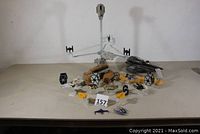 Front view of Escape from Jakku playset with TIE fighters and several small Star Wars planes scattered around, along with a Star Wars craft vehicle on the right.