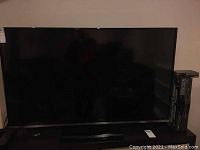 Front view of a 54-inch JVC flat-screen HD television on a stand.