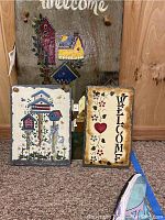 Three slate welcome signs arranged showing all artwork and sizes.