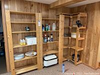 Three wooden shelving units side by side in basement