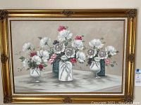 Frontal photo of the floral oil painting showing three flower arrangements in vases on a neutral background with white, pink and purple flowers.