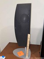 Martin Logan side bookshelf speaker on silver stand displayed front-on with ruler for scale