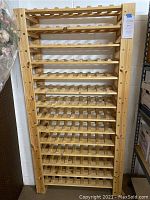 Front full view of the tall light wood wine rack showing all shelves