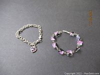 Two sterling silver bracelets shown on black background