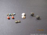 Four pairs of vintage earrings arranged on gray background including stone and pearl 12K GF, silver tone disc 'Forbes' engraved, 14K opal and ear drop earrings with finish loss