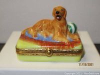Front view of hand-painted dog atop box