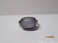 Front view of a chalcedony cabochon ring showing the translucent light blue rectangular stone.