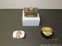 Overall view of all three boxes showing the rectangular decorative casket, heart shaped box, and small pill box
