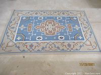 Overview of the dhurrie area rug showing full design and border
