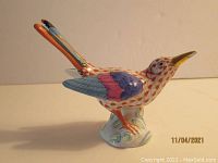 Side/front view of hummingbird showing fishnet pattern and overall shape