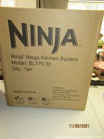 Box front view showing Ninja Mega Kitchen System Model BL77030 with quantity and branding details.